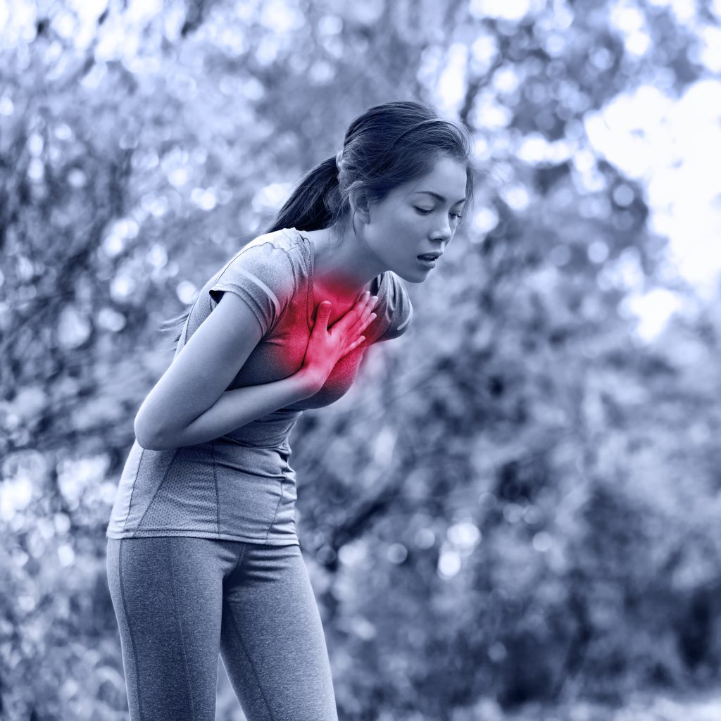 Nausea nauseous and sick ill runner vomiting. Running woman fe